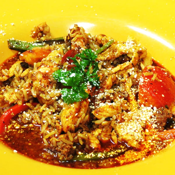 Osorio's Latin Fusion's Mexican chicken and rice dish, garnished with parsley and cotija cheese.