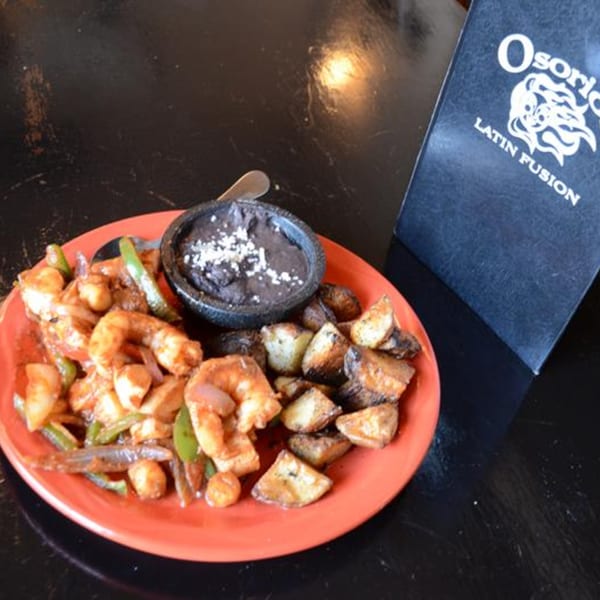 Osorio's Latin Fusion shrimp dish with roasted potatoes and a side of black beans.