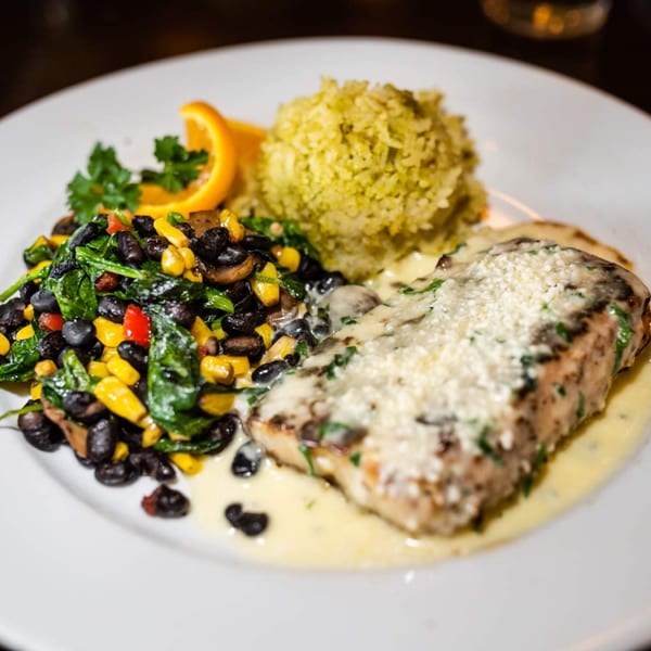 Osorio's Latin Fusion dish with fish, black beans, corn, spinach, and rice.