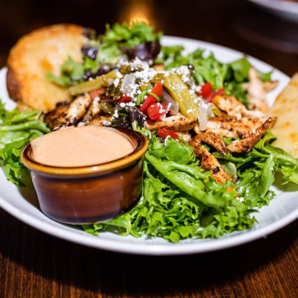 Osorio's Latin Fusion chicken salad with dressing, cheese, peppers, and toasted bread.