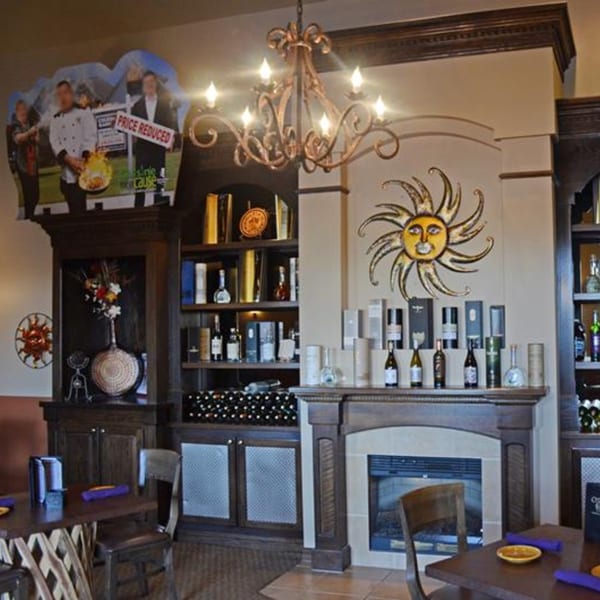 Osorio's Latin Fusion dining room with a fireplace, wine bottles, and a sun decoration.