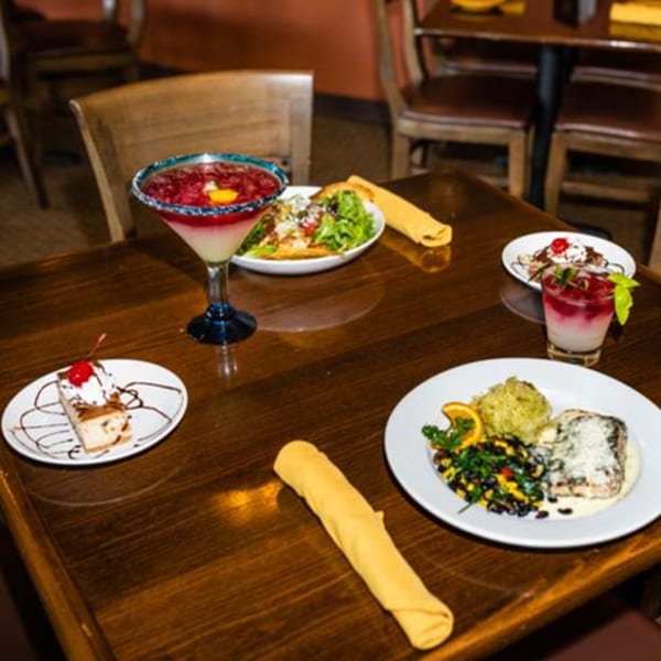 A table at Osorio's Latin Fusion with Mexican dishes, drinks, and desserts.