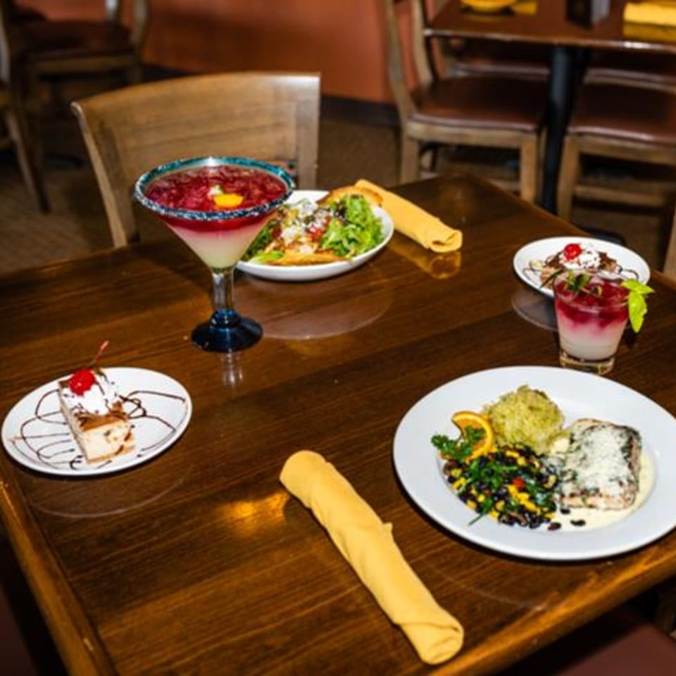 A table at Osorio's Latin Fusion with Mexican dishes, drinks, and desserts.